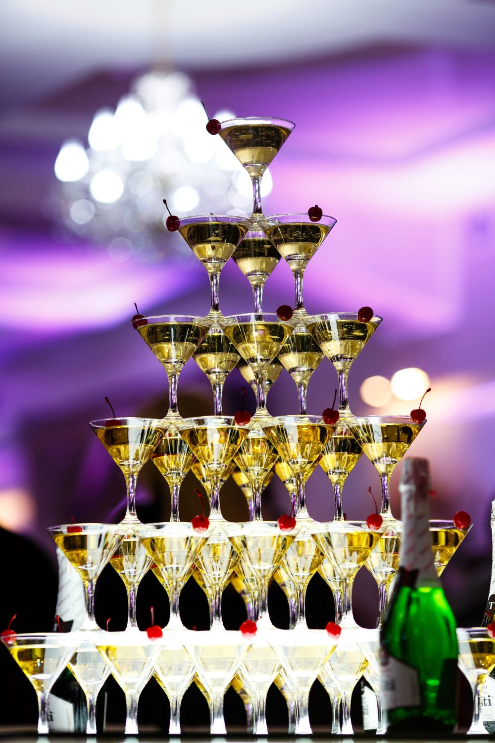Pyramid of cocktails decorated with cherries stands on the table